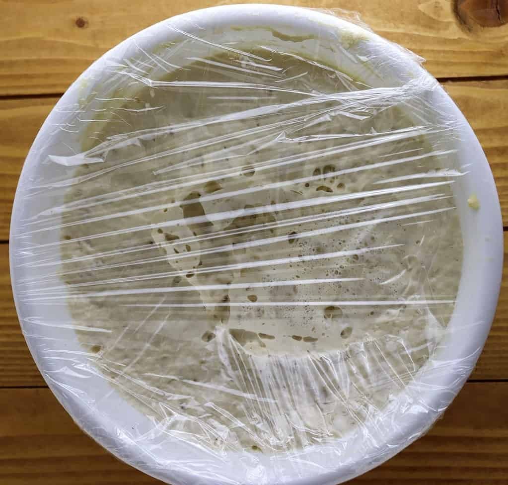 black pepper focaccia dough resting in the refrigerator
