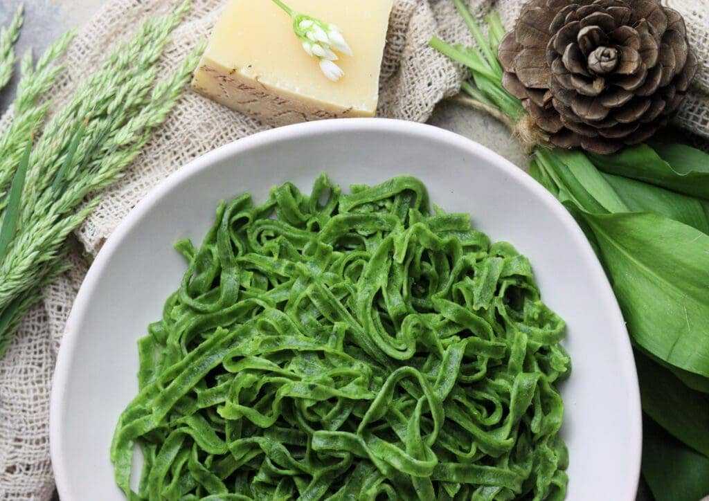 beautiful serving of homemade fresh green wild garlic pasta 