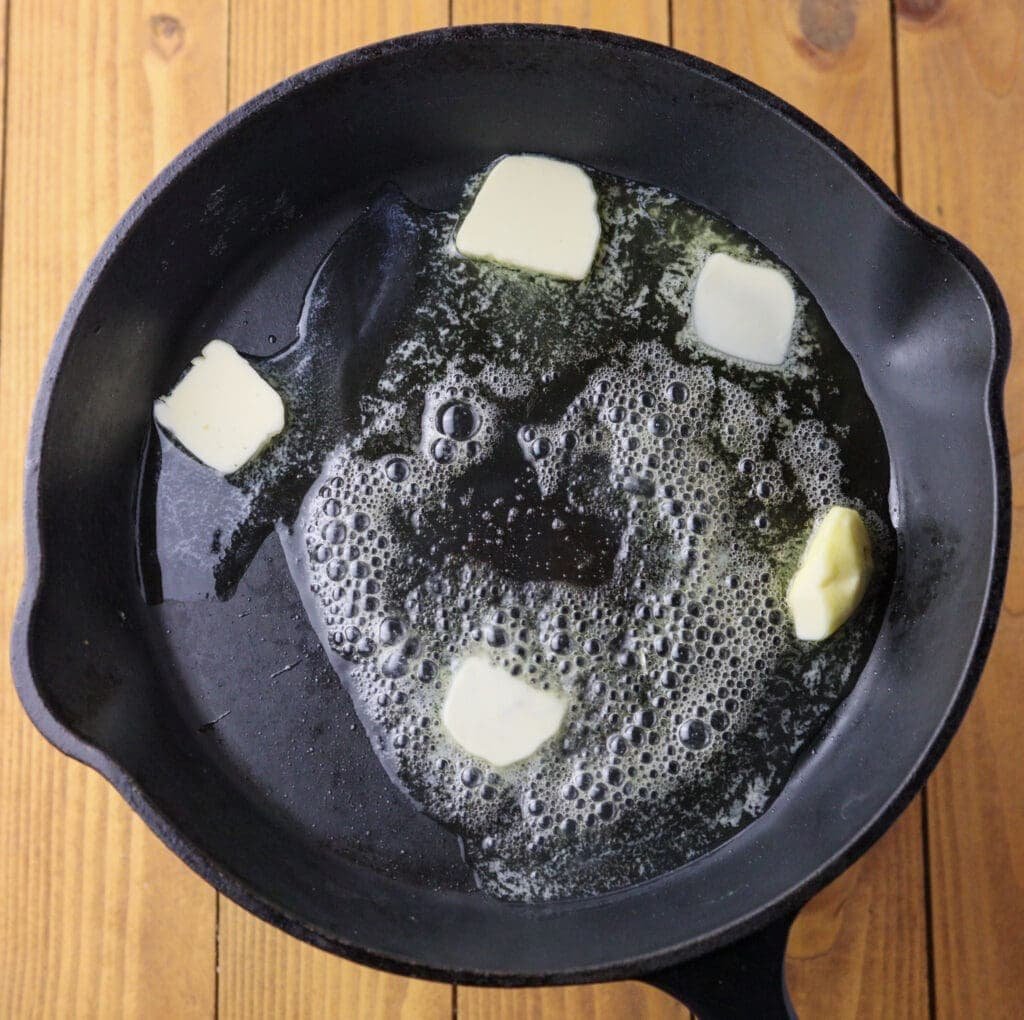 Melting slices of butter in a pan. 