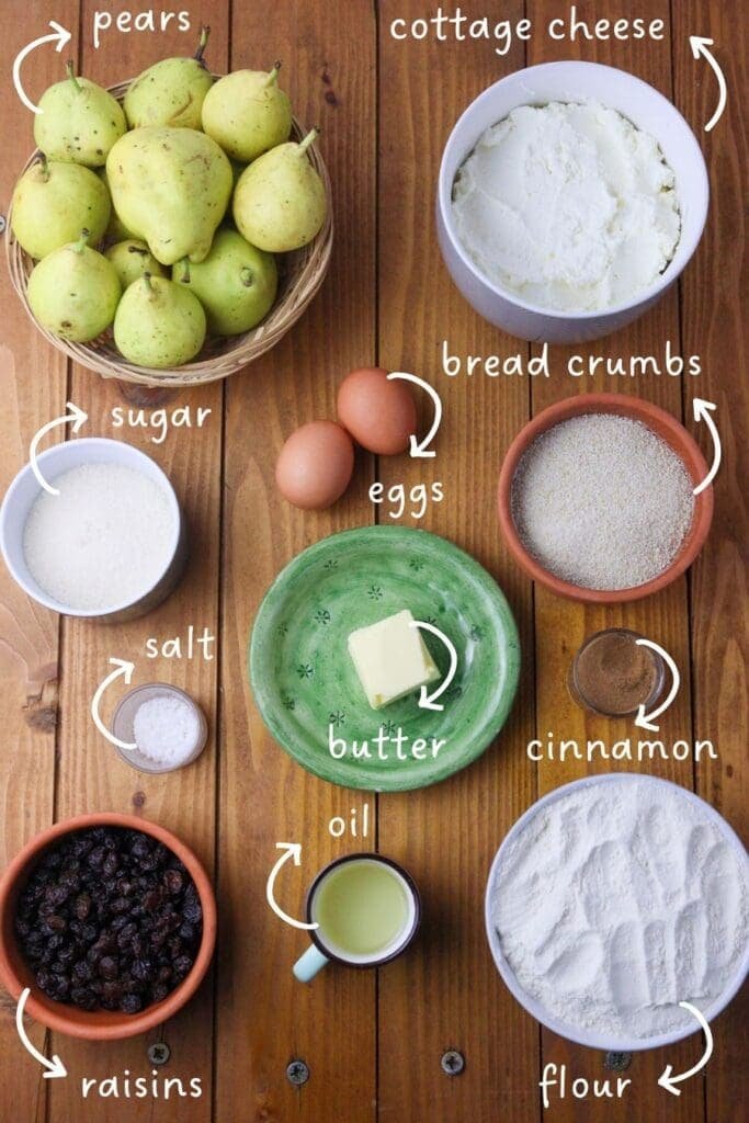 Gathering pear cheese strudel ingredients: flour, pears, cottage cheese, sugar, eggs, raisins, cinnamon, bread crumbs, oil and butter