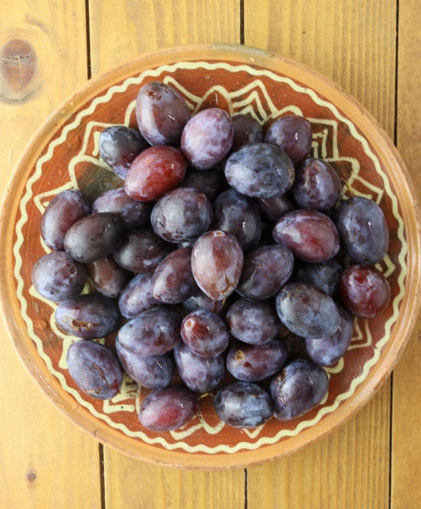 A plate full of fresh plums.