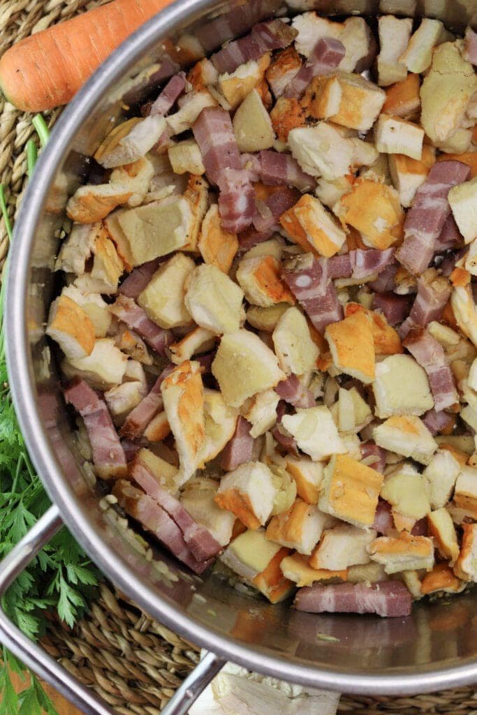 Adding the chicken of the woods and smoked ribs to the pot.