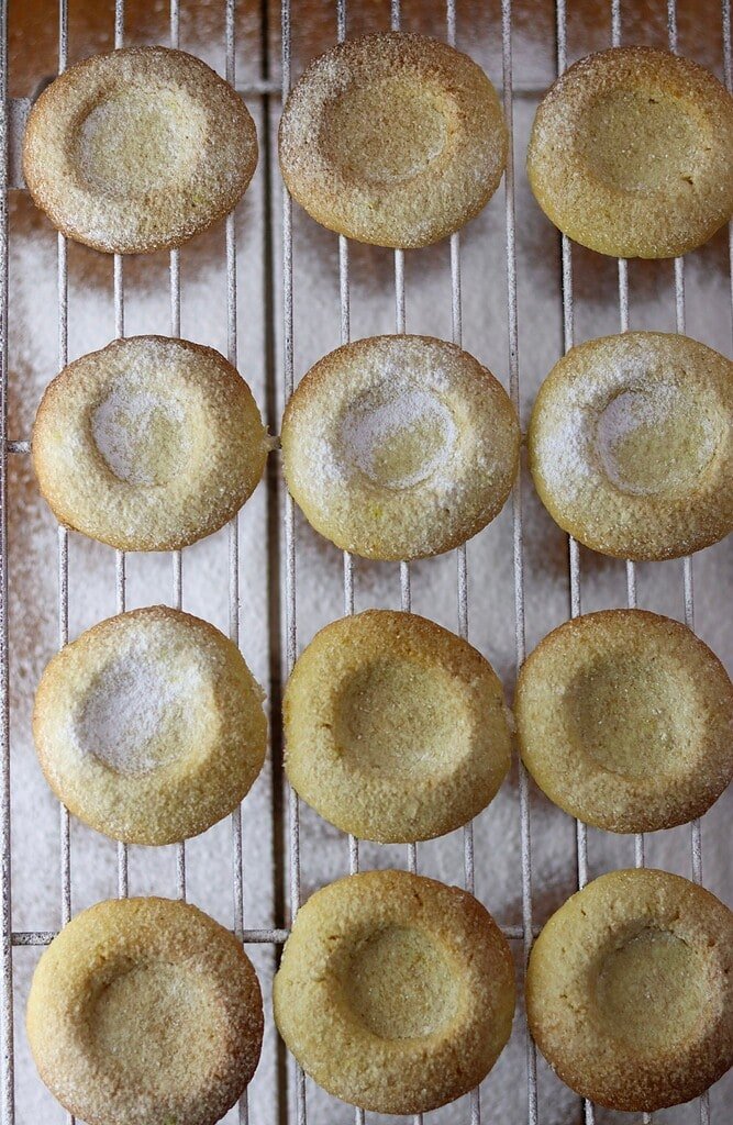 Freshly baked cookies on a cooling rack, just sprinkled with powdered sugar.