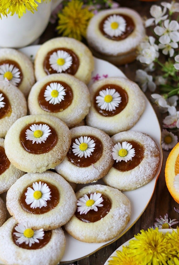 Beautiful dandelion cookies served on the table with flower decoration.