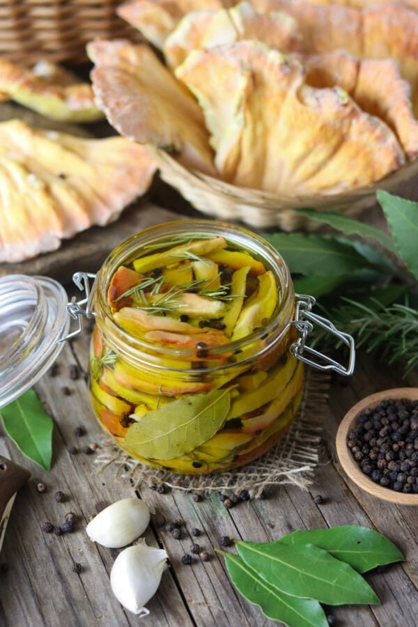 Pickling chicken of the woods mushrooms with garlic, bay leaves and whole black pepper.