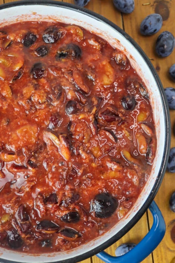 Plums slowly simmering in the pot, before they reduce into a jam consistency.