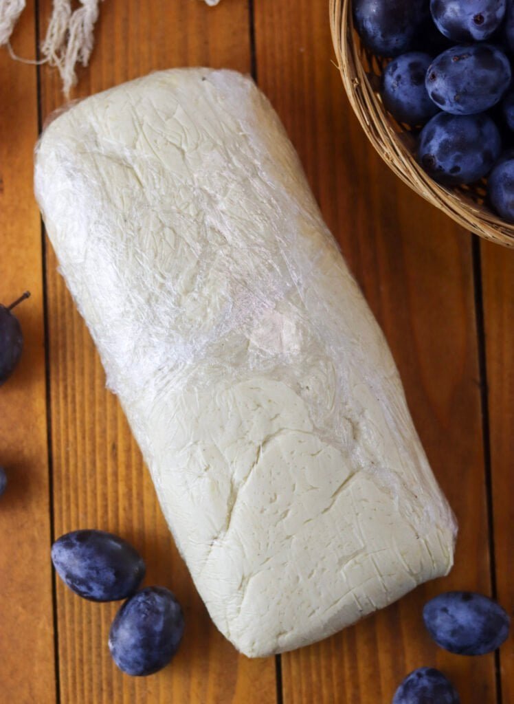 Spelt flour and cottage cheese dough, wrapped in plastic foil, to chill in the fridge before making plum dumplings.
