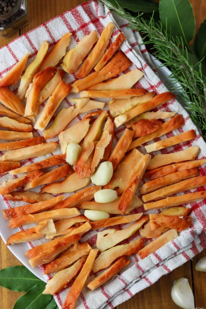 Chicken of the woods slices drying on a clean kitchen cloth.