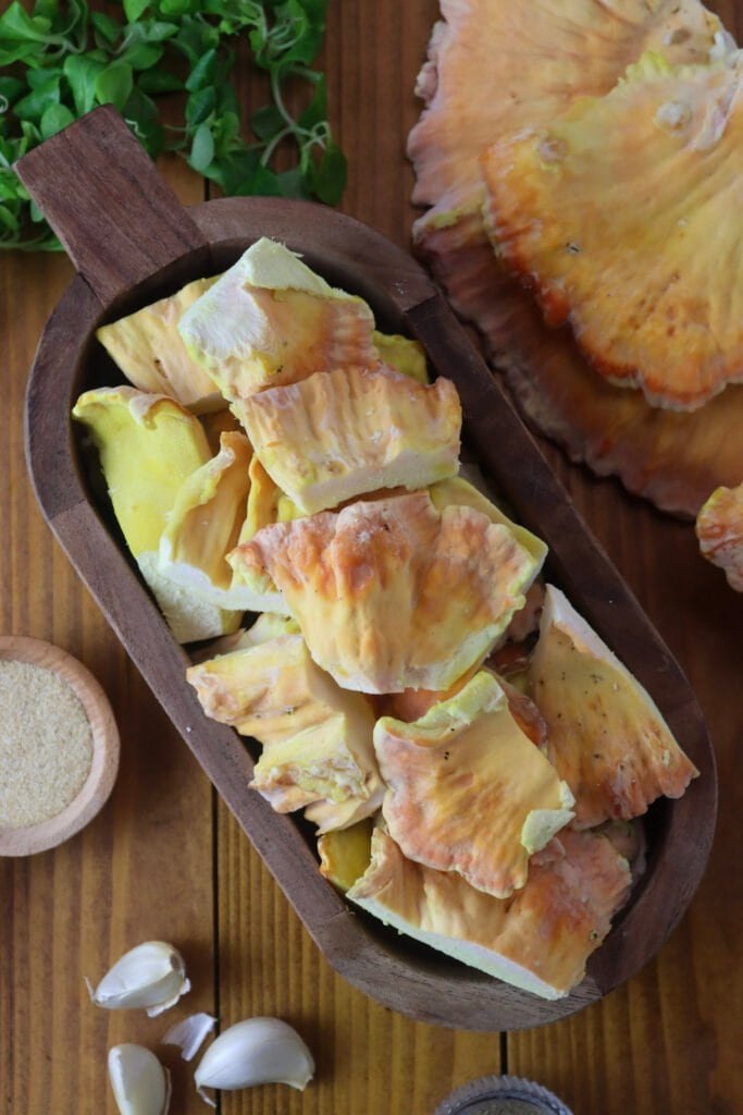 A bowl of clean, sliced chicken of the woods mushroom ready for frying.