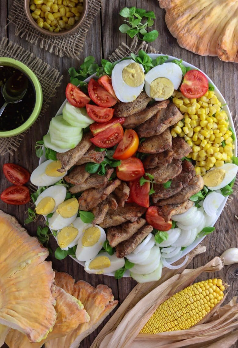 Fried chicken of the woods mushroom salad recipe with corn, eggs, tomato, cucumber, onion and lamb's lettuce.