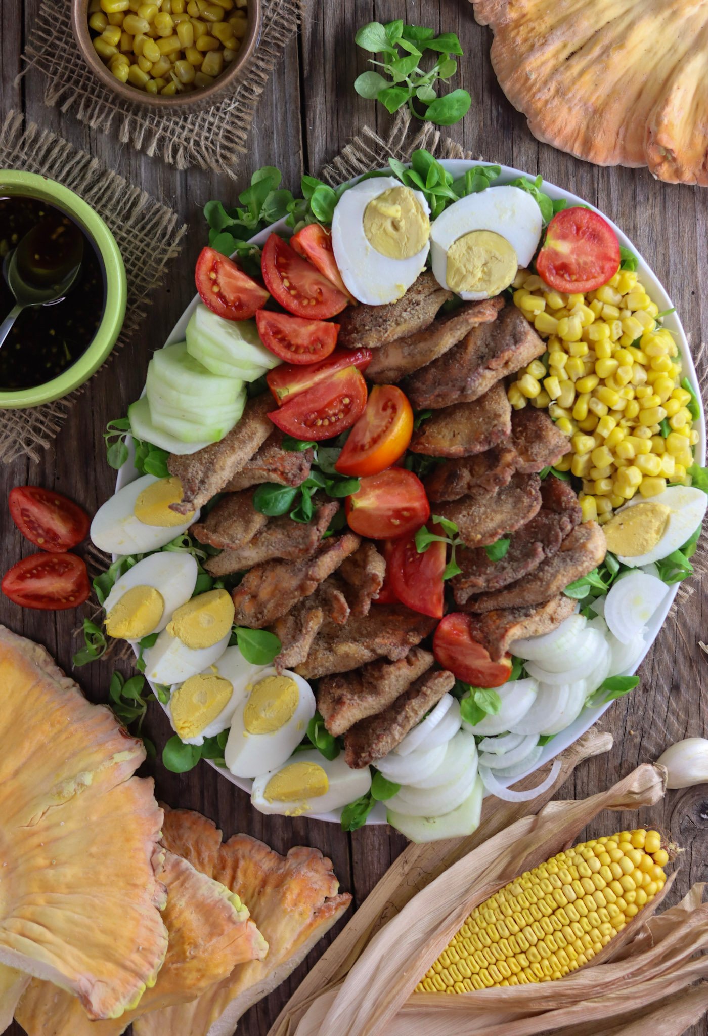 Fried chicken of the woods mushroom salad recipe with corn, eggs, tomato, cucumber, onion and lamb's lettuce.