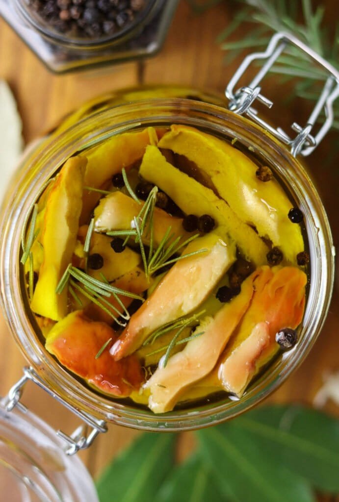 Top view of a jar with pickled chicken of the woods mushrooms in olive oil