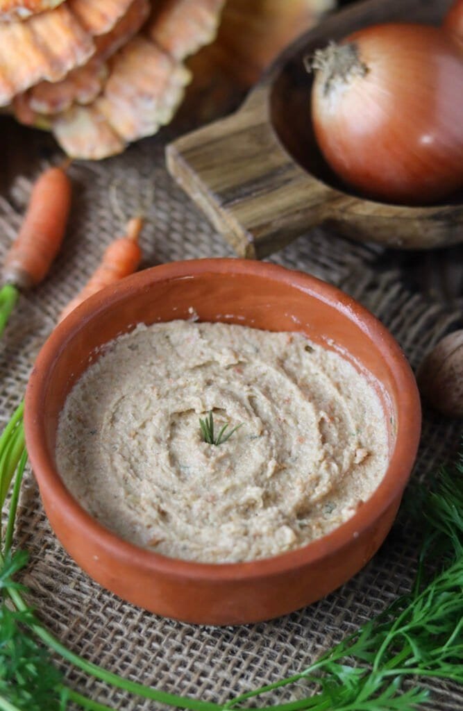 a small bowl of pickled chicken of the woods mushroom spread with cream cheese.