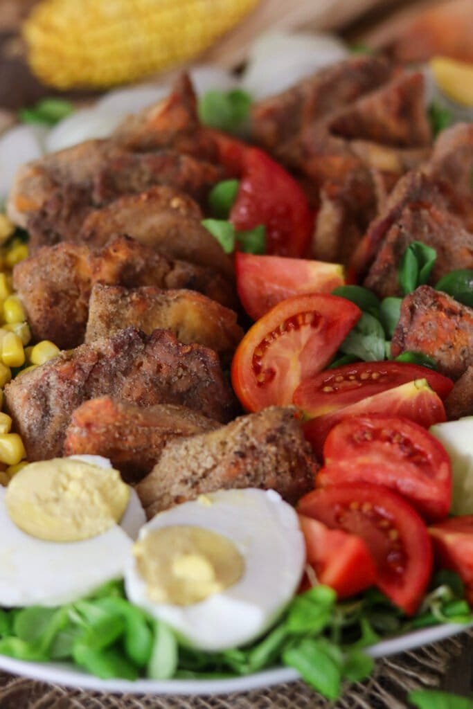 A close view of fried chicken of the woods mushroom nuggets on a decorated salad plate.