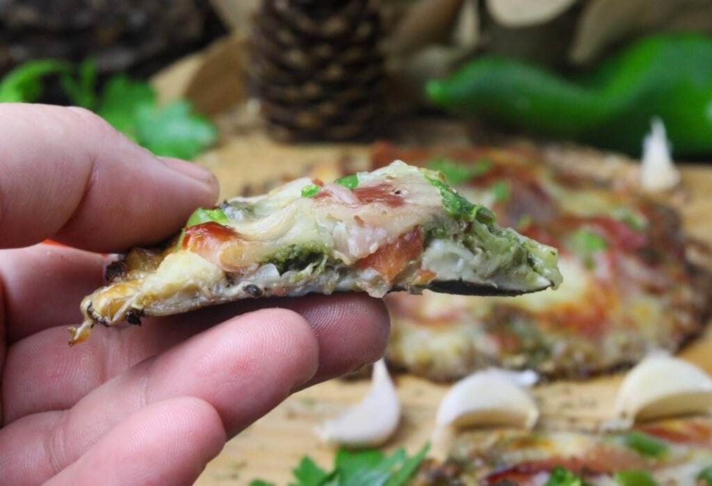 A delicious slice of parasol mushroom pizza in my hand.