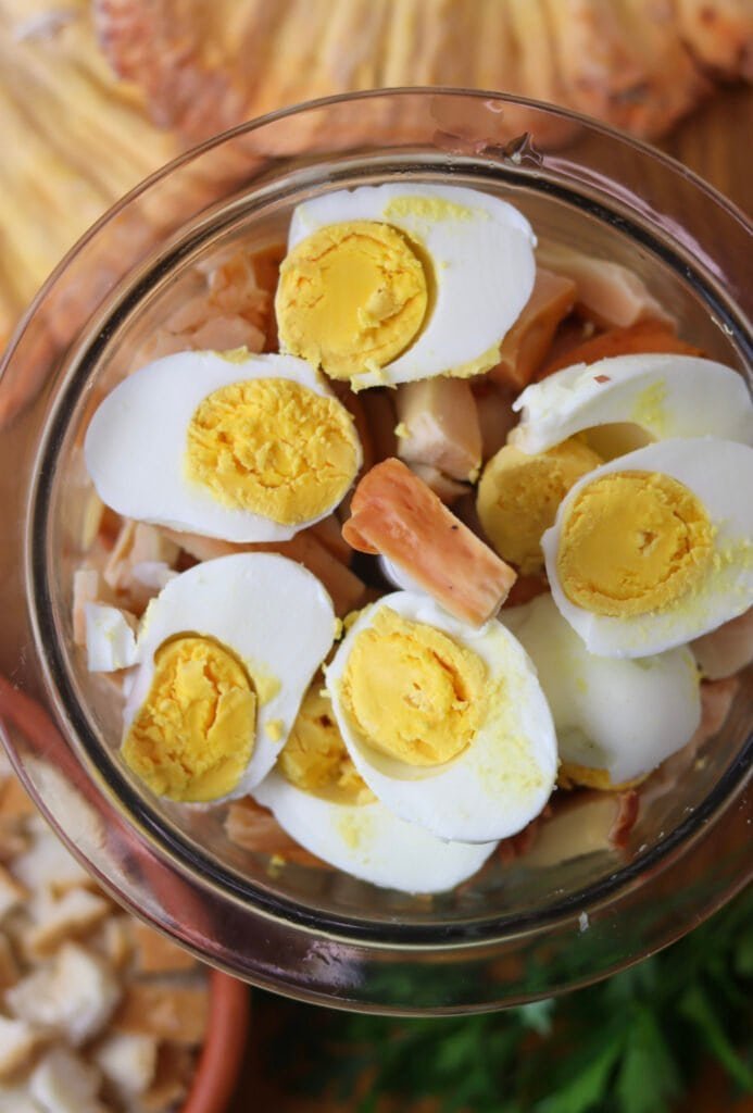 Cooked mushroom slices and egg halves in a blender.