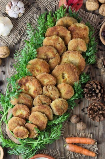 Breaded saffron milk cap mushrooms served on a wooden table.