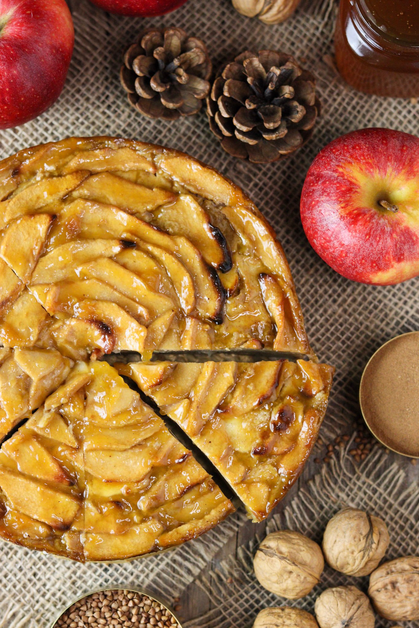 Top view of a buckwheat apple cake recipe, a gluten-free apple cake with honey and a glossy apricot glaze.