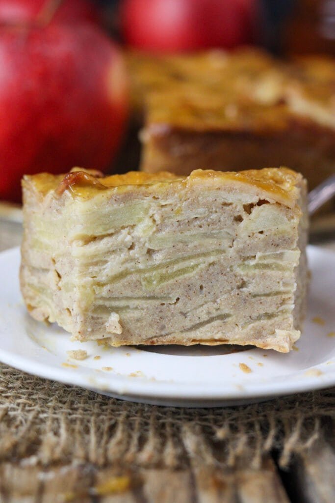 A close view of buckwheat apple cake slice with visible apple and buckwheat layers.