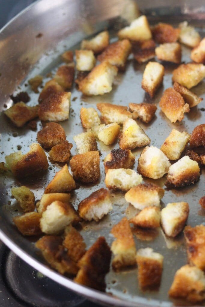 Bread croutons in a frying pan.