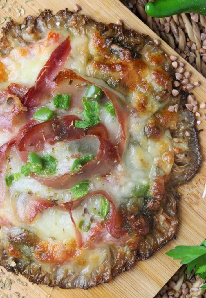 Parasol mushroom (Macrolepiota procera) pizza with prosciutto, mozzarella, tomato and pepper.