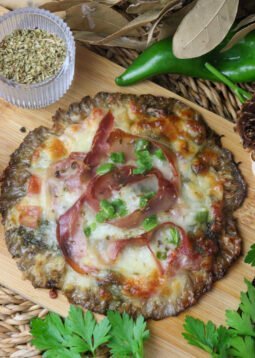 Delicious parasol mushroom pizza on a parasol mushroom crust, topped with tomato, pepper, mozzarella, pesto and prosciutto.