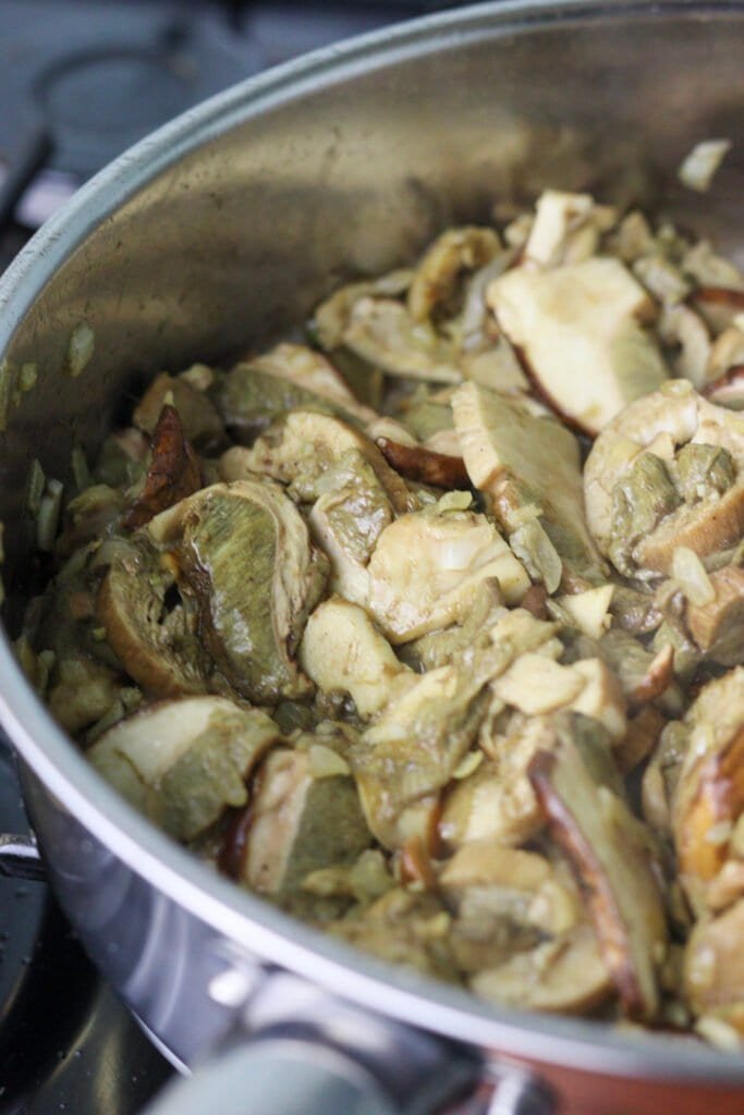 Porcini mushrooms in a pan, just being sauteed with onions.