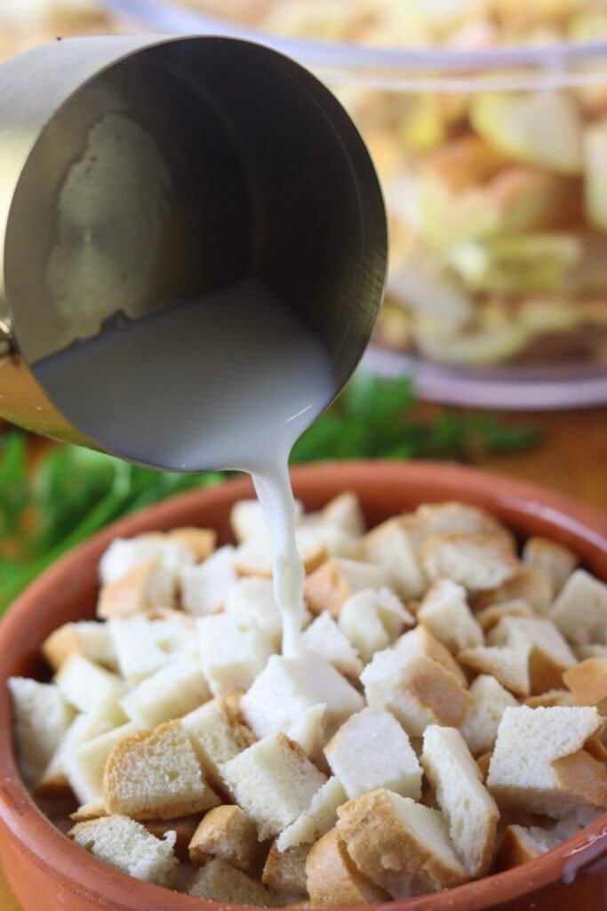 Soaking old bread slices in warm milk.