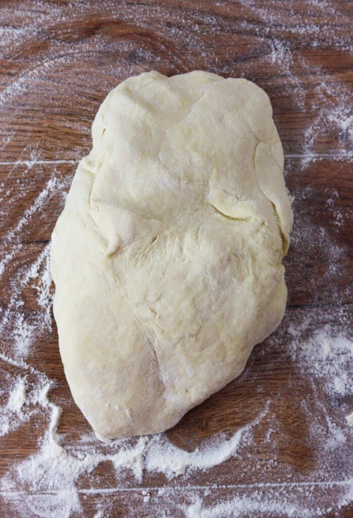 The dough on a floured surface, ready for kneading.