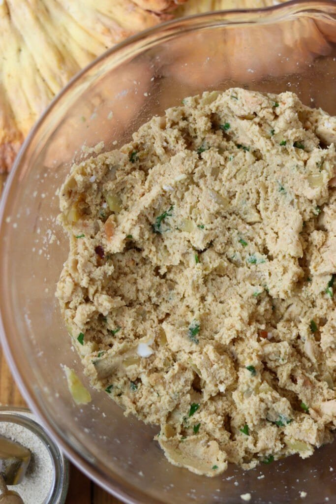 Adding the mushroom and egg mixture and breadcrumbs to the fritter mixture.