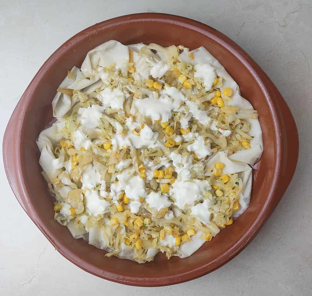 image showing how to add sour cream mixed with eggs between the layers