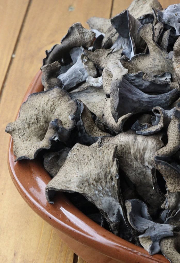 image of cleaned and striped black trumpet mushrooms