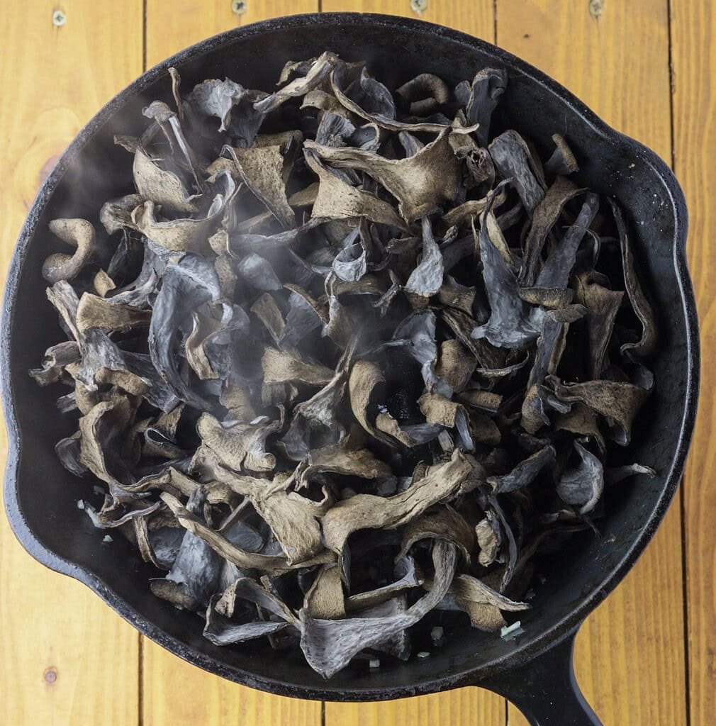 image showing how to add black trumpets to the pan