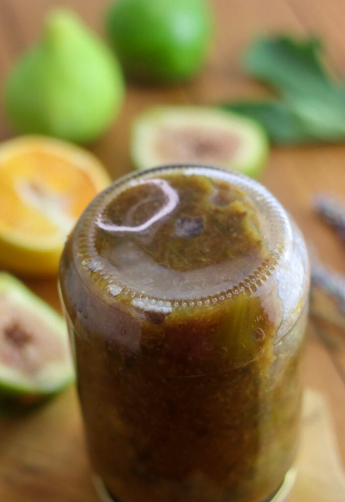 Hot fig jam in a jar, turned upside down, ready to be slowly cooled under a blanket.