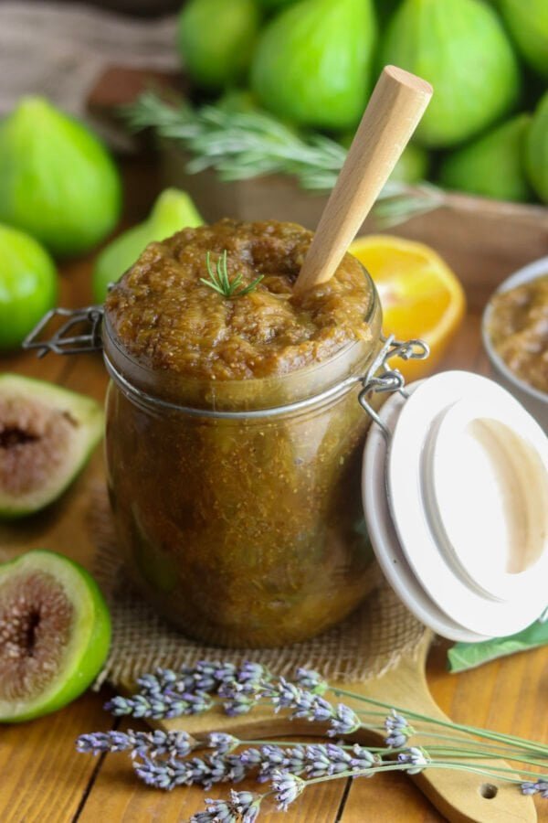 Sugar free fig jam in a canning jar, with fresh figs in the background.